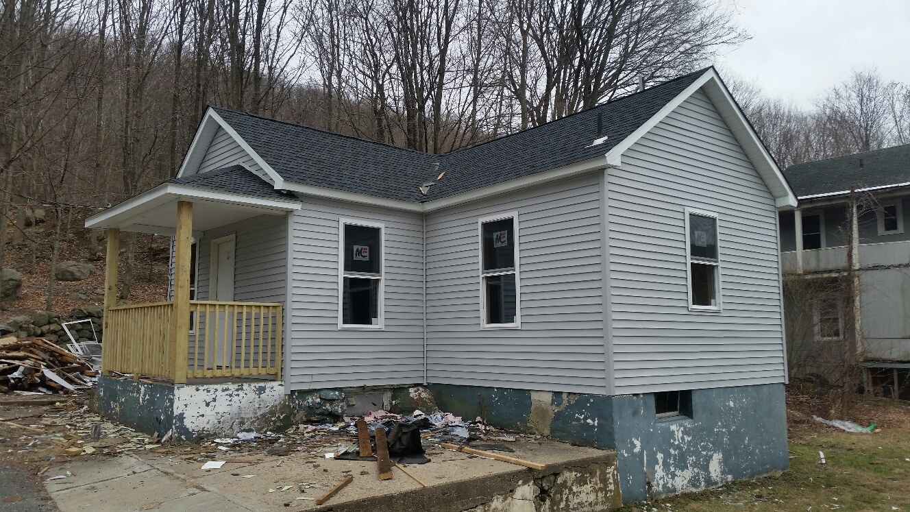 House post repairs with updated paint and windows.