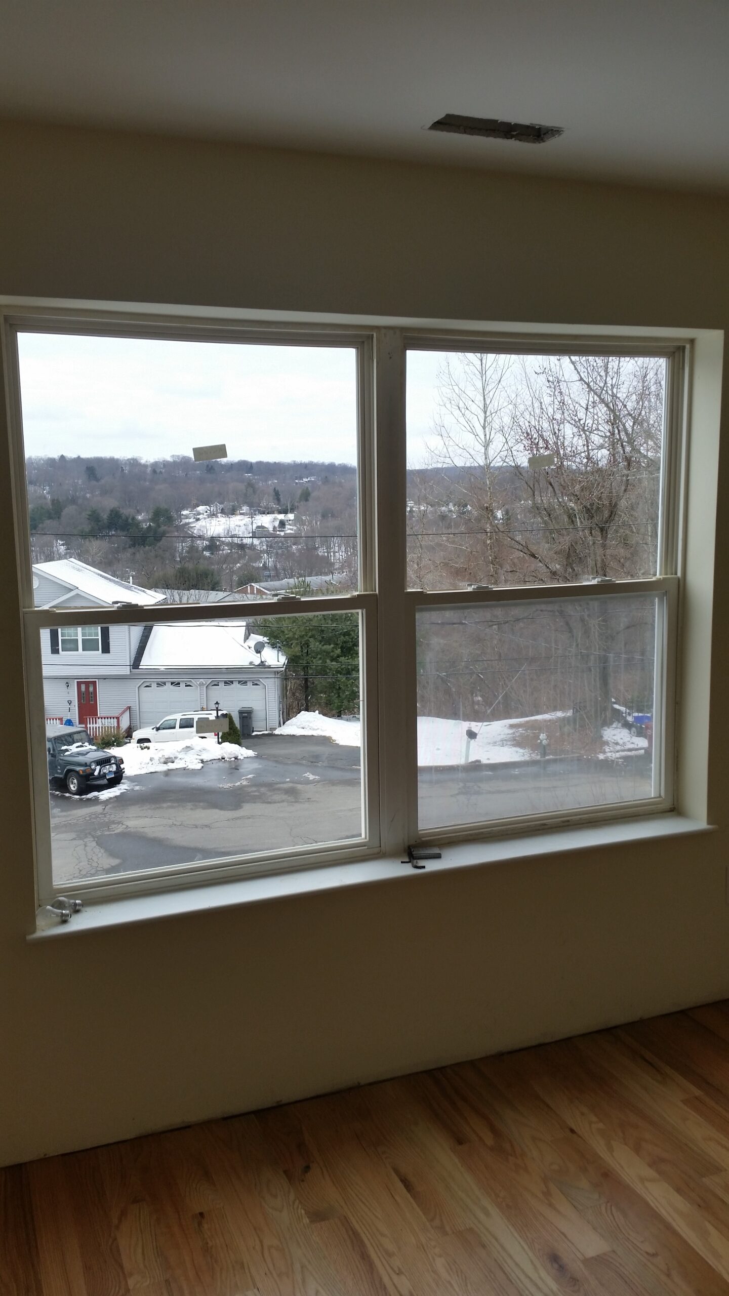 Window that is free of fog above a wood floor.